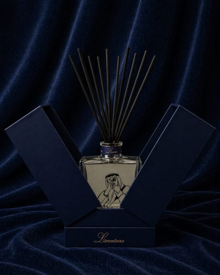 Lammtarra reed diffuser with clear fragrance and black reeds in the open navy gift box on navy velvet